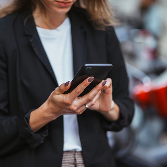 A woman with a mobile phone in her hand