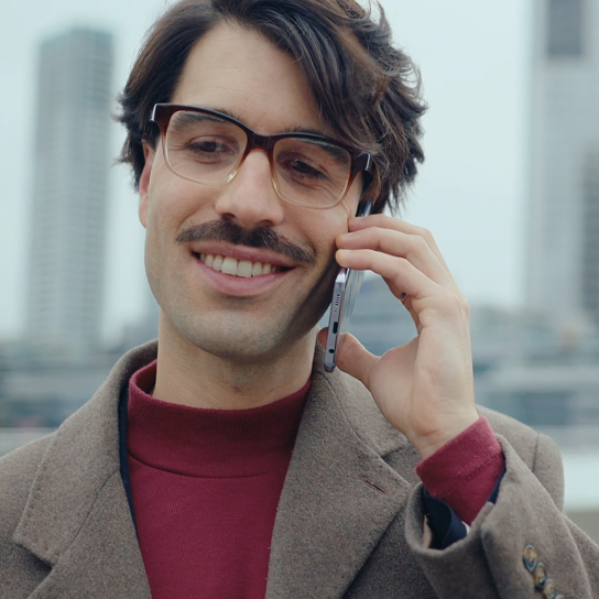 A man with a cell phone in his hand on a phone call