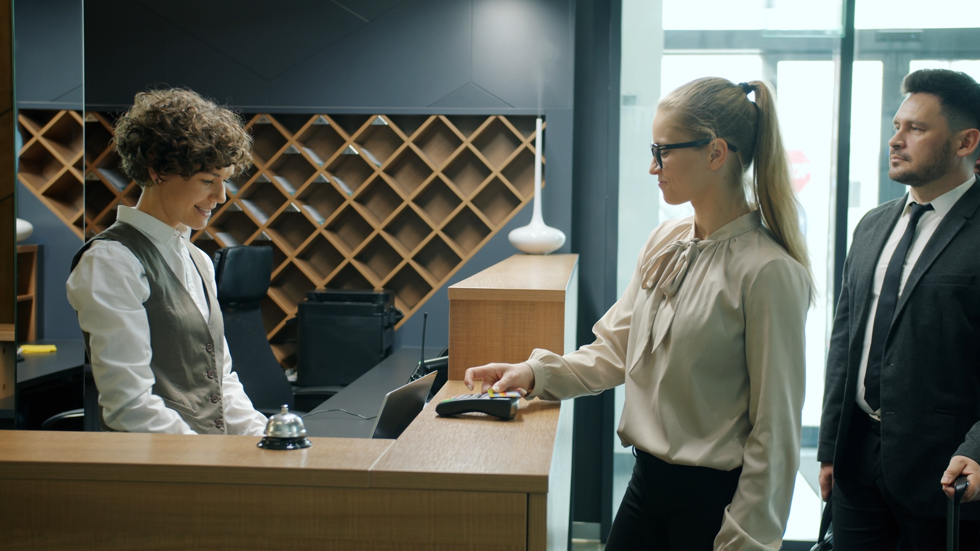 A woman making a payment at a reception desk
