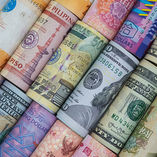 several banknotes together representing multi-currency