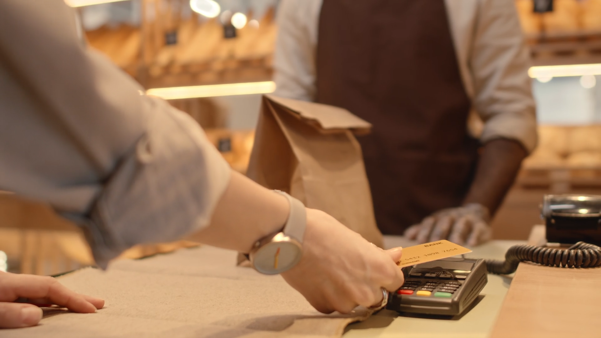 Making a card payment at a POS terminal inside a store.
